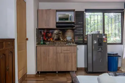 a kitchen with a refrigerator and a microwave at Coliving Belen Malibu in Medellín