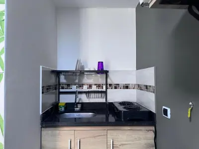 a small kitchen with a sink and a stove at Coliving Belen Malibu in Medellín