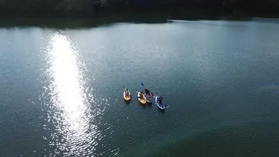 three boats on a body of water at Hostería Florida Tropical in Santa Fe de Antioquia