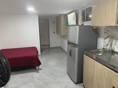 a small kitchen with a sink and a refrigerator at Villa Loreto Aparta estudio 202 in Medellín