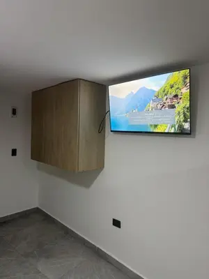 a flat screen tv on a wall in a room at Villa Loreto Aparta estudio 202 in Medellín