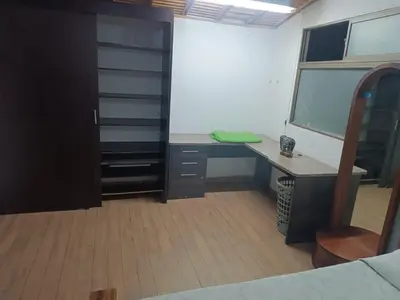 an office with a desk and a window in a room at Alcoba amplia con cama doble in Envigado