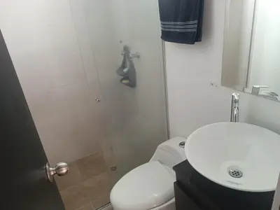 a bathroom with a toilet and a sink and a shower at Alcoba amplia con cama doble in Envigado