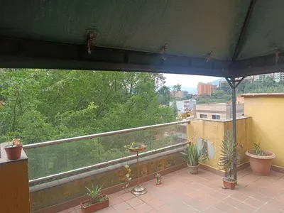 a balcony with potted plants on top of a building at Alcoba amplia con cama doble in Envigado