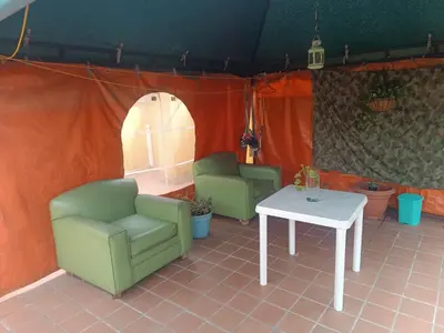 a room with two chairs and a table at Alcoba amplia con cama doble in Envigado