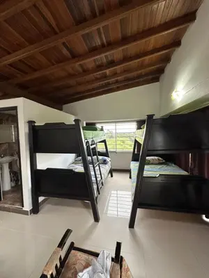 a room with three bunk beds in a room at Casa en Marinilla cerca a guatape y el peñol in Marinilla