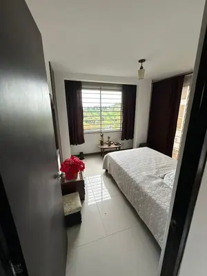 a bedroom with a bed and a window at Casa en Marinilla cerca a guatape y el peñol in Marinilla