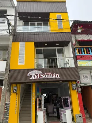 a yellow and black building with a store at Hotel El Samán in Quinchía