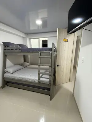 a room with two bunk beds and a door at Hotel El Samán in Quinchía