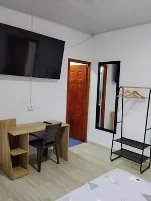 a room with a desk and a television on a wall at Apartaestudios Santa Ana in Ruiosucio