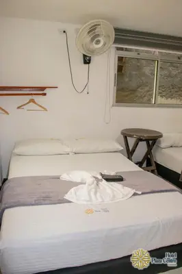 a bed in a room with a remote control on it at Hotel Plaza Centro Cocorná in Cocorná