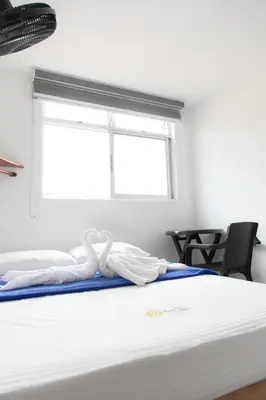 a bedroom with a bed with two swans at Hotel Plaza Centro Cocorná in Cocorná