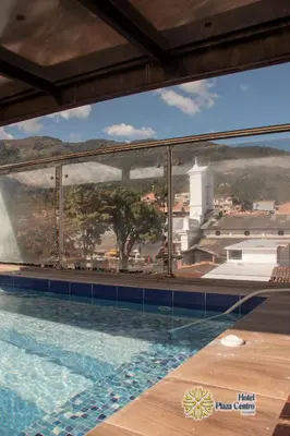 a swimming pool with a view of a mountain view at Hotel Plaza Centro Cocorná in Cocorná