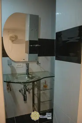 a bathroom with a glass sink and a mirror at Hotel Plaza Centro Cocorná in Cocorná