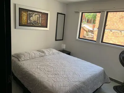 a bedroom with a bed and a window at Natural charm in Medellín in Medellín