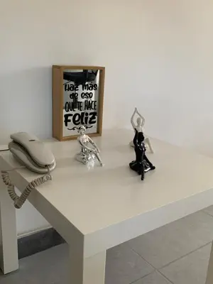 a white table with a phone and some figurines on it at Natural charm in Medellín in Medellín