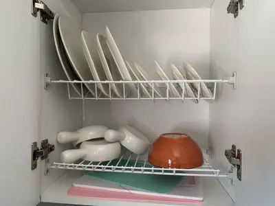 a shelf with plates and bowls in a refrigerator at Natural charm in Medellín in Medellín