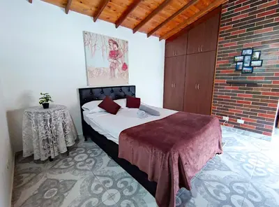 a bedroom with a bed and a table in it at Acogedor apartamento cerca al tranvía 301 in Medellín