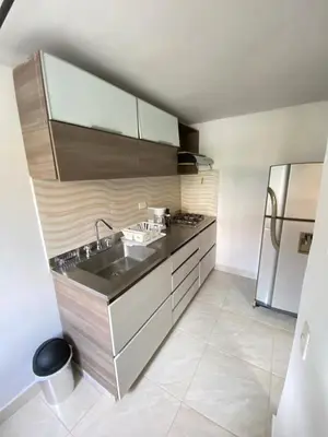 a kitchen with a sink and a refrigerator at Acogedor apartamento cerca al tranvía 201 in Medellín