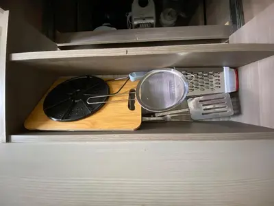 a kitchen utensils are sitting on top of a shelf at Acogedor apartamento cerca al tranvía 201 in Medellín