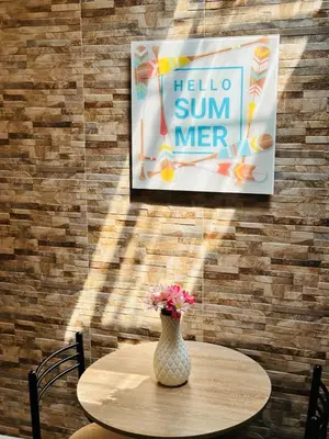 a table with a vase of flowers on a wall at Apartaestudio San Diego Medellín in Medellín