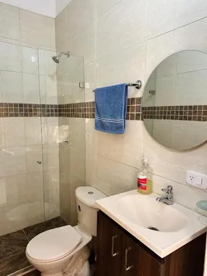 a bathroom with a toilet and a sink and a mirror at Apartaestudio San Diego Medellín in Medellín