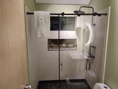 a shower with a glass door in a bathroom at Kristal Luxury - Guatapé in El Peñol