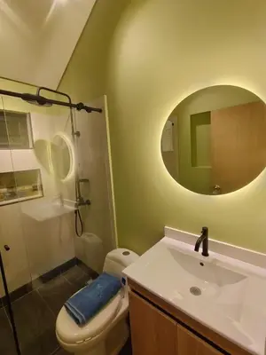 a bathroom with a toilet and a sink and a mirror at Kristal Luxury - Guatapé in El Peñol