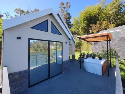 a large white shed with a bath tub and a roof at Kristal Luxury - Guatapé in El Peñol
