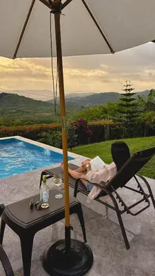 a woman laying in a chair under an umbrella at Escápate Sonata in Chinchiná