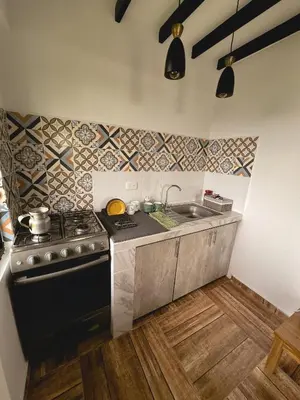 a kitchen with a stove and a sink at Escápate Sonata in Chinchiná