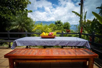 a table with a bowl of fruit on top of it at Hermosa Casa y Cabañas en Barbosa, Antioquia in Barbosa