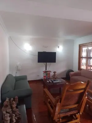 a living room with a couch and a tv at Relax West Finca Hotel in Santa Fe de Antioquia