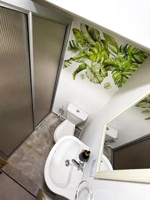 a bathroom with a toilet and a sink and a mirror at Casa La Morada in Medellín