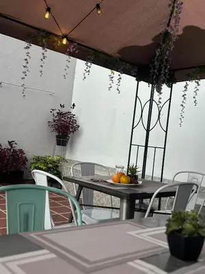 a table and chairs on a patio with fruit on it at Casa La Morada in Medellín