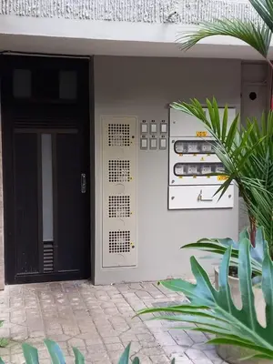 a building with a black door and a plant at Loft Belén WiFi900Mb Av 33 Cr 70 l Balcón Vista in Medellín