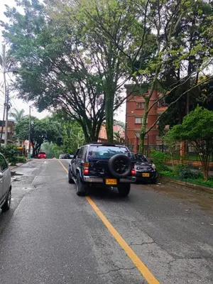 a black car parked on the side of a road at Loft Belén WiFi900Mb Av 33 Cr 70 l Balcón Vista in Medellín