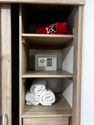 a cabinet with a microwave and towels in it at Loft Belén WiFi900Mb Av 33 Cr 70 l Balcón Vista in Medellín