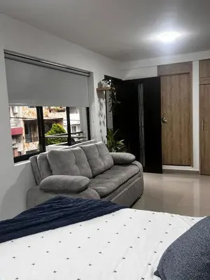 a living room with a couch and a bed at Loft Belén WiFi900Mb Av 33 Cr 70 l Balcón Vista in Medellín