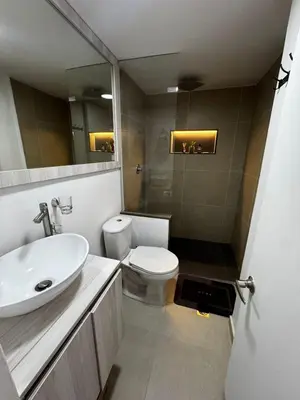a bathroom with a sink and a toilet and a mirror at Best location in El Poblado y Provenza in Medellín