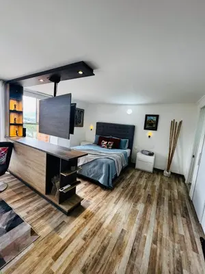 a bedroom with a bed and a desk at Best location in El Poblado y Provenza in Medellín