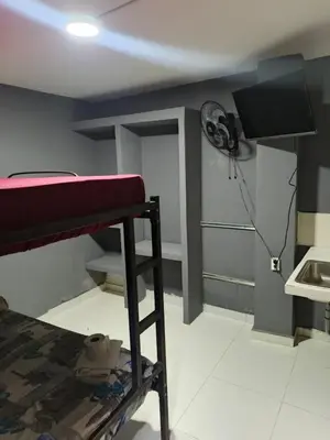 a room with a bunk bed and a fan at Dulce Hogar Aparta Hotel in Medellín