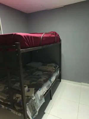a bunk bed with a red sheet on top of it at Dulce Hogar Aparta Hotel in Medellín