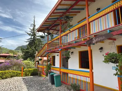 a building with orange and white paint on it at Hostería El Paraíso in Jardin