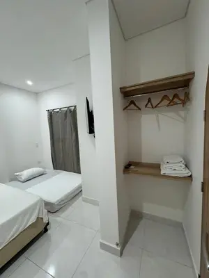 a small room with a bed and a closet at Habitaciones en Doradal 202 in Doradal