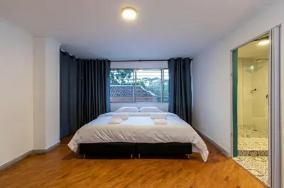 a bedroom with a bed and a large window at P202 4BR Poblado Apartment at Poblado Provenza in Medellín