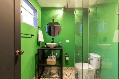 a green bathroom with a sink and a toilet at P202 4BR Poblado Apartment at Poblado Provenza in Medellín