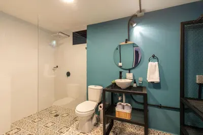 a bathroom with a toilet and a sink and a mirror at P202 4BR Poblado Apartment at Poblado Provenza in Medellín