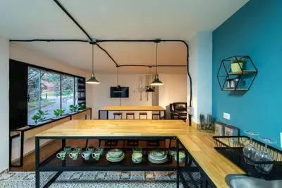 a living room with a table and a blue wall at P202 4BR Poblado Apartment at Poblado Provenza in Medellín