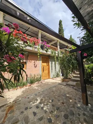 a house with flowers on the side of it at Finca El Encanto in Jericó